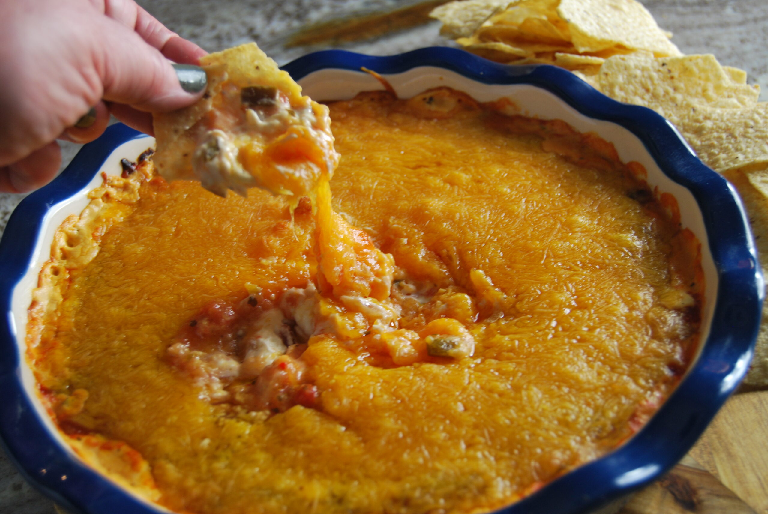 cheesy peach salsa dip being served on  tortilla dip 