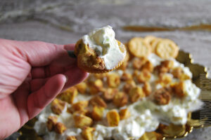 Fried dill pickle dip being served on a cracker