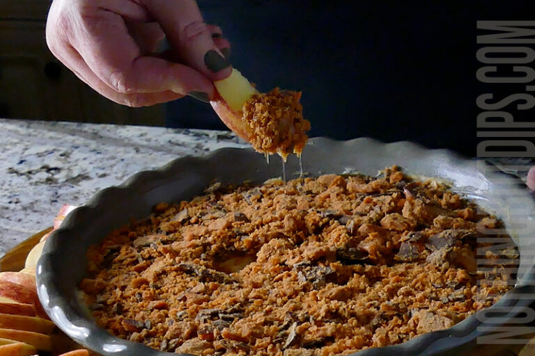 dipping an apple into the caramel apple dip