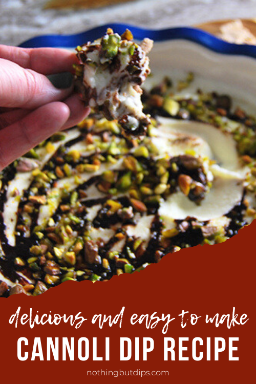 Cannoli dip topped with chocolate syrup and pistachios and served with a cannoli chip