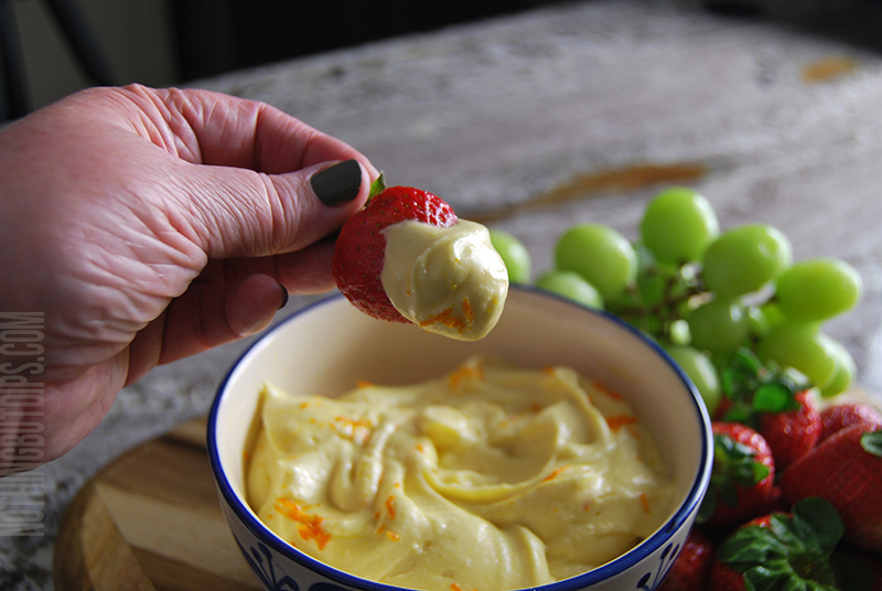  With a hand blender, mix together cream cheese, orange juice concentrate and vanilla. 
 Then slowly mix in the powdered sugar until smooth. 
 Transfer the mixture into a serving dish. 
 Garnish with orange zest. 