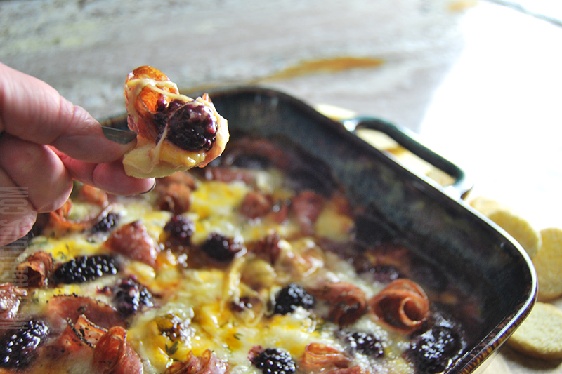 baked charcuterie dip served on toast chip