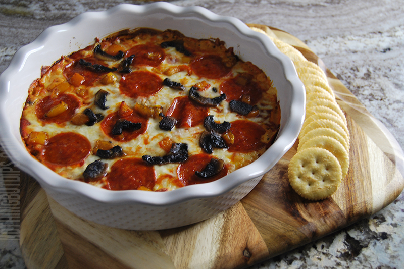 Cheesy pepperoni pizza dip served with crackers