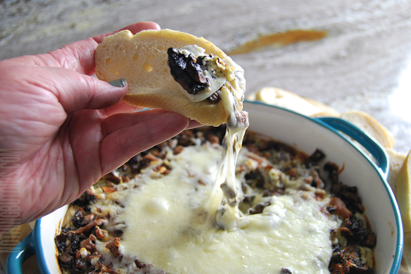 Stuffed mushroom dip with melty mozzarella cheese served on toasty bread