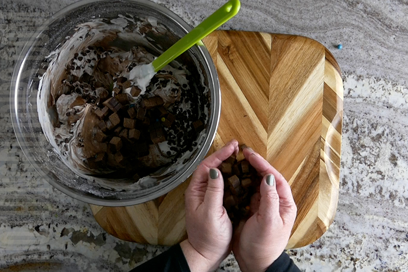 place the brownie bits into the bowl with the cream mixture to create brownie bites dip