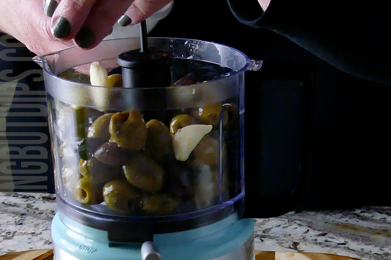 add garlic to the ingredients in the food processor