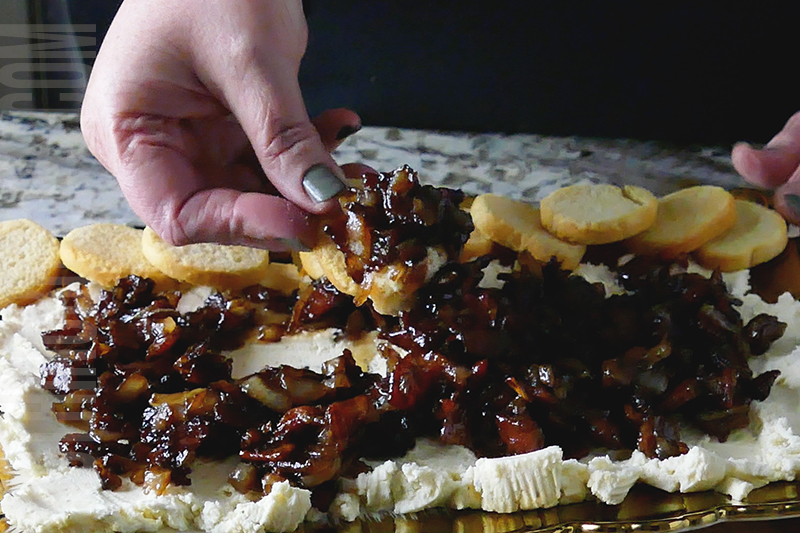 Boursin with bacon onion jam dip being served on a crostini