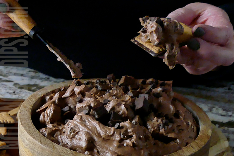Chocolatey brownie bits dip served on a wafer cookie