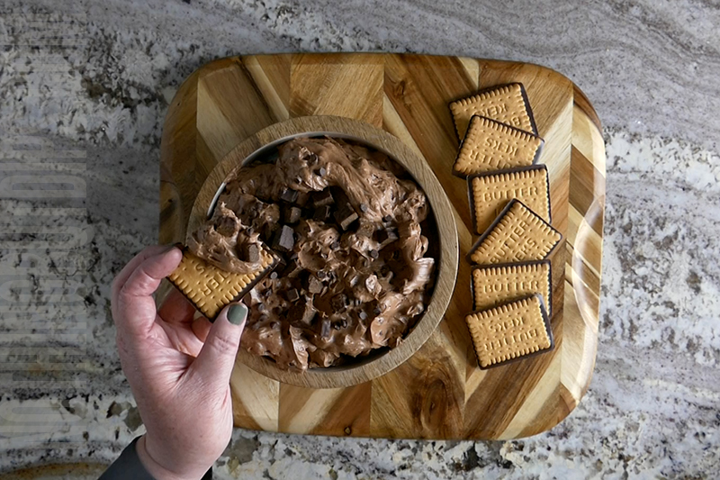 Chocolatey brownie bits dip served on a wafer cookie