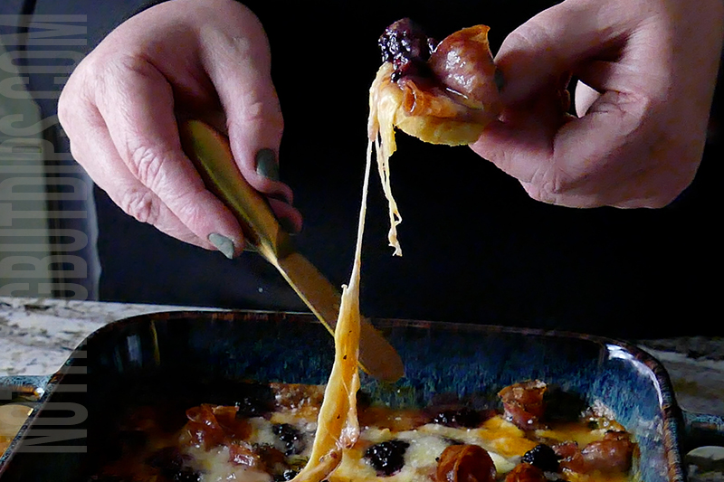baked charcuterie dip served on toast chip