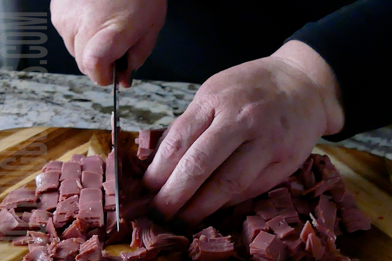 chopping corned beef for Reuben dip