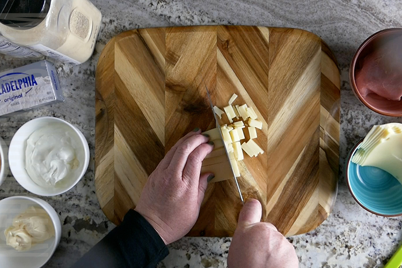 chopping Swiss cheese for Reuben dip