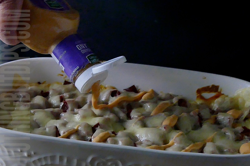 Drizzling Thousand Island dressing onto Reuben dip