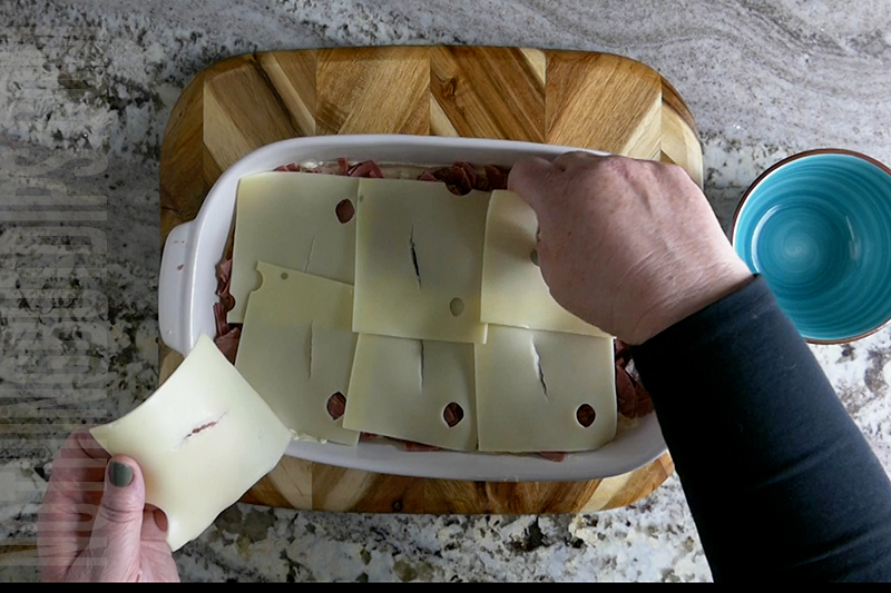 Layering Swiss cheese onto Reuben dip