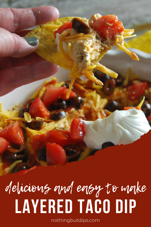 easy layered taco dip served on a tortilla chip