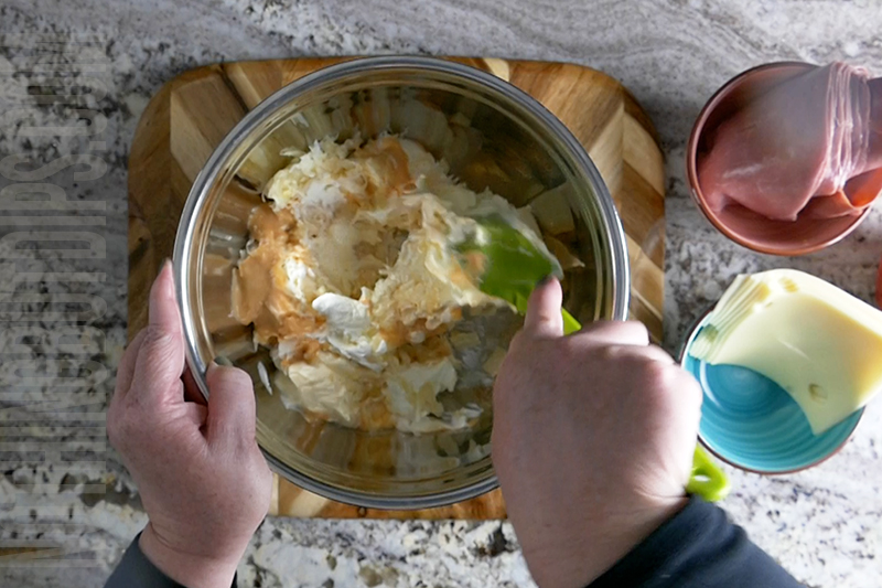 Mixing the ingredients for a Reuben dip