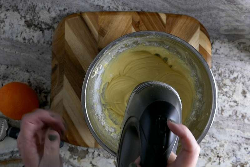 using a hand mixer to blend the ingredients for easy fruit dip
