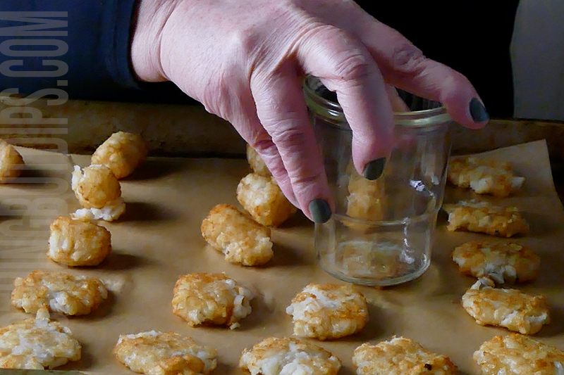using a small glass to smash the tater tot chips