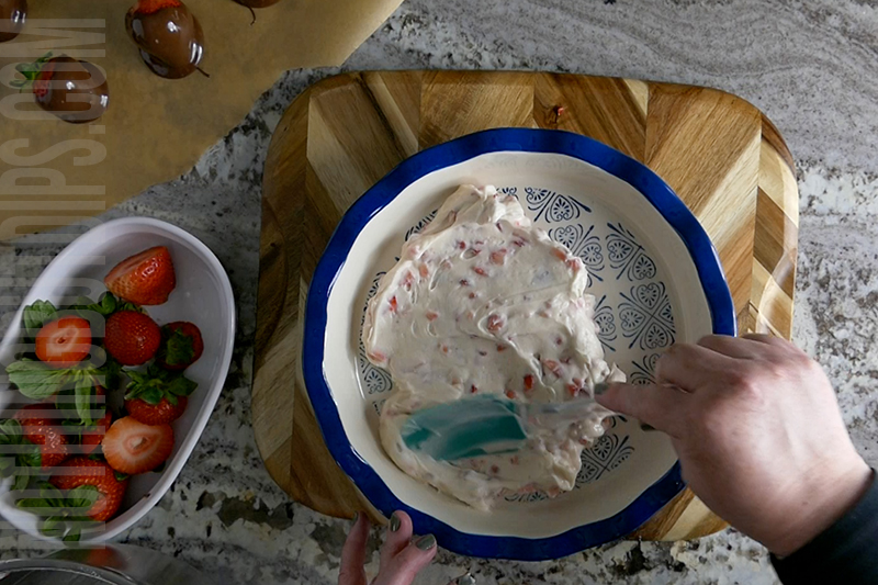 spread the creamy base for the chocolate covered strawberries dip into a pie plate