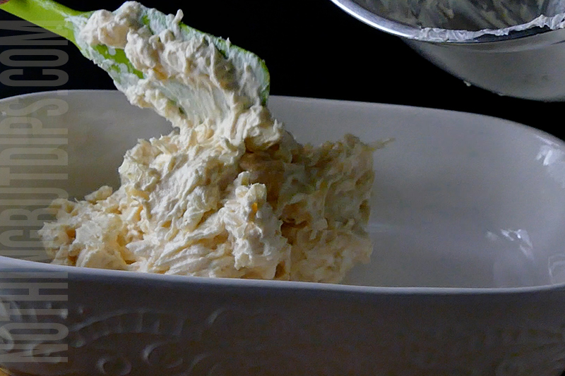 Transferring the creamy mixture for the Reuben dip into a serving dish