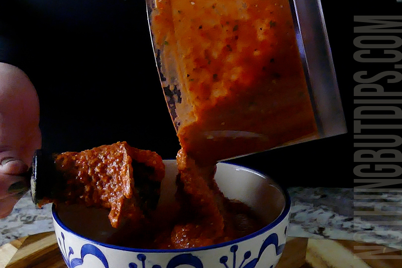 transferring the roasted red pepper dip puree to a serving container
