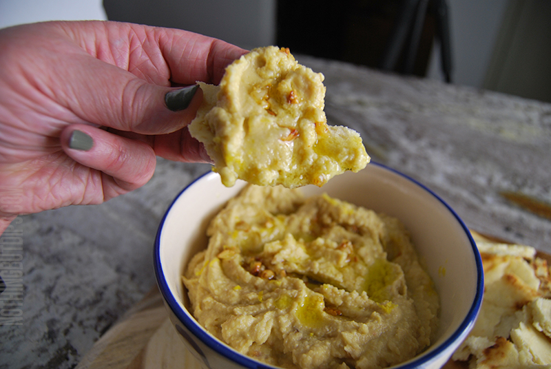 Easy homemade lemon garlic hummus dip served on warm pita bread