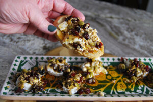 easy and delicious marinated goat cheese dip served on a garlic toastie