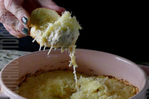 Easy potluck dish parmesan garlic wing dip served on garlic bread toast