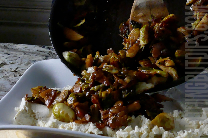 laying the brussels and bacon over Boursin cheese to form a dip