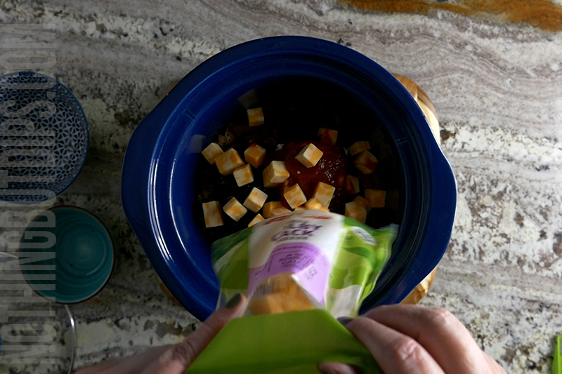 cubed colby jack cheese being added to sweet and sour beef and cheese dip (aka put a ring on it cheese dip)