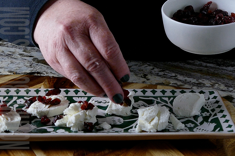 adding sweetened dried cranberries to the goat cheese medallions