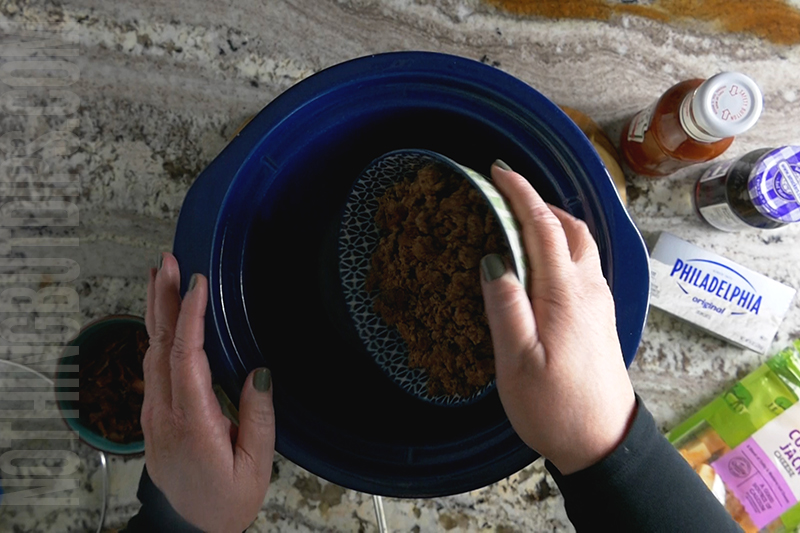 cooked ground beef being added to sweet and sour beef and cheese dip (aka put a ring on it cheese dip)