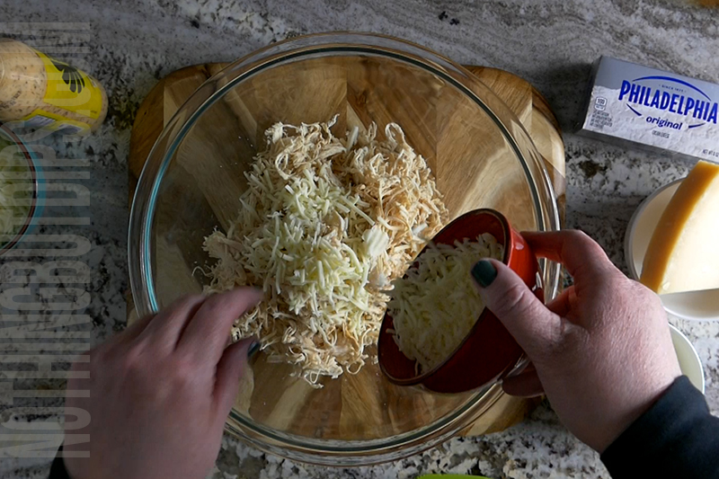 adding mozzarella cheese to the mixing bowl