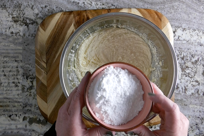 adding the powdered sugar to the bowl for key lime pie dip