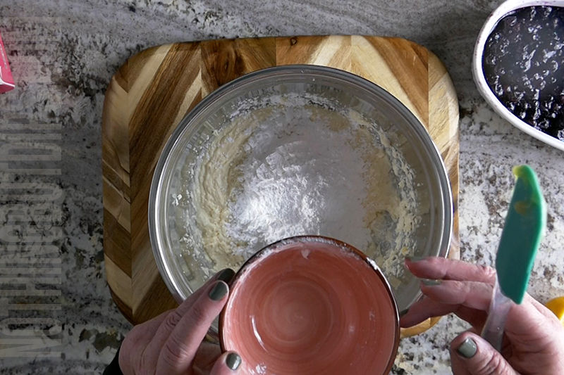 adding powdered sugar to the creamy lemon dip base