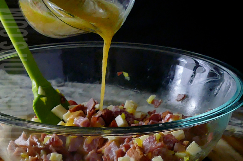 pouring the vinaigrette to finish off Italian sub dip