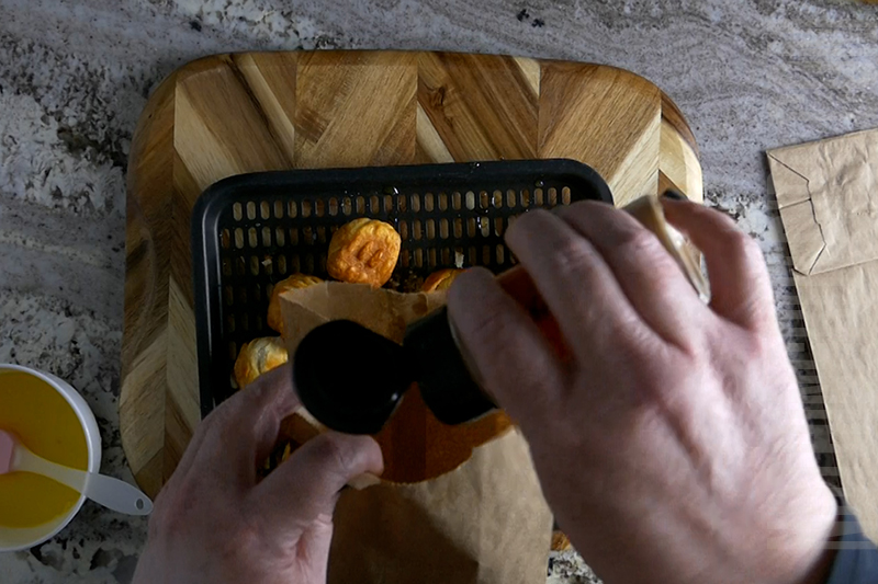 adding cinnamon to a paper lunch bag