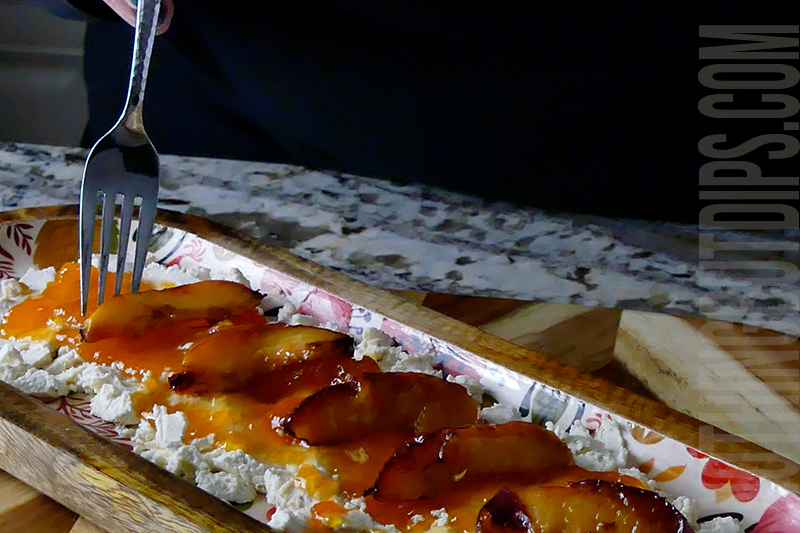 adding grilled fruit to the top of the Boursin and jam dip appetizer