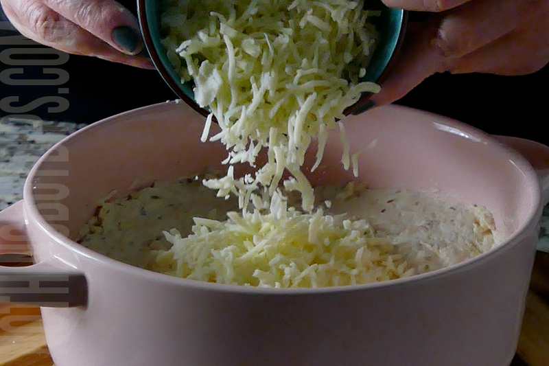 adding shredded mozzarella to the top of the chicken mixture to make parmesan garlic wing dip