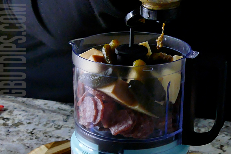 adding mustard to the mini food processor