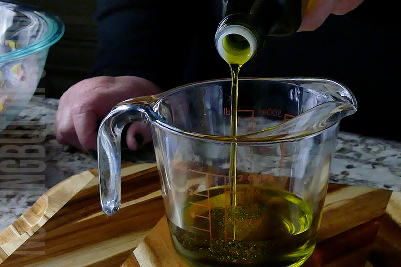 adding oil to make vinaigrette dressing for Italian sub dip