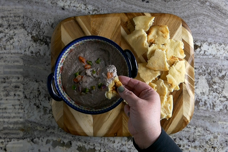 creamy black bean dip puree served on pita bread