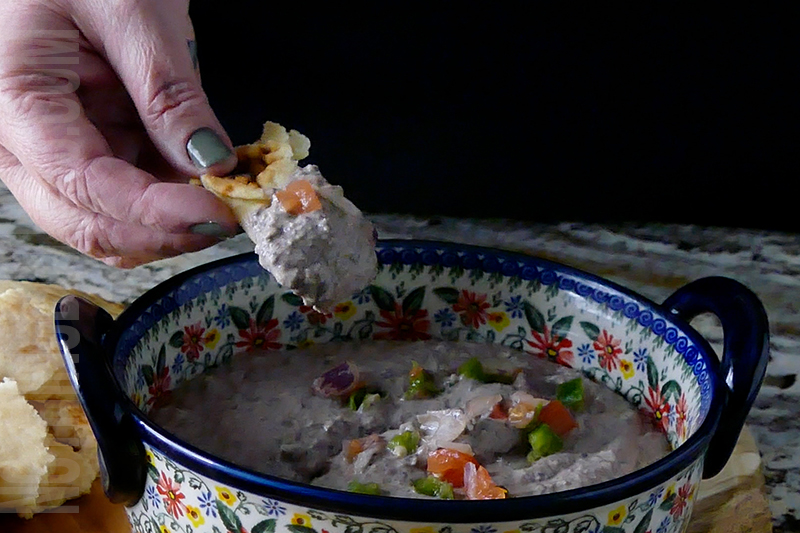 creamy black bean dip puree served on pita bread 