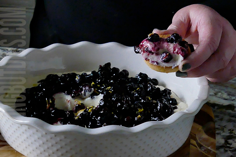 creamy blueberry and lemon dip being served on a shortbread cookie 
