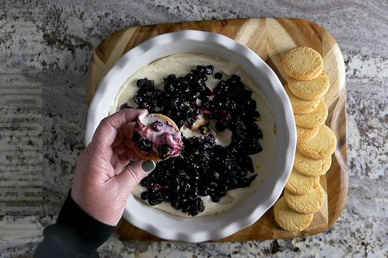 creamy blueberry and lemon dip being served on a shortbread cookie