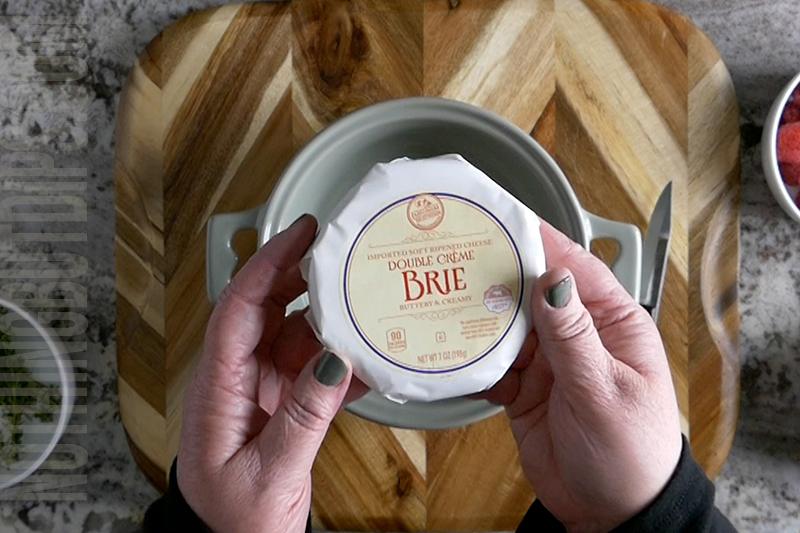 a wheel of brie in its package
