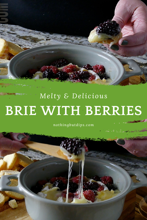 Brie with Berries and herbs being served on crusty bread