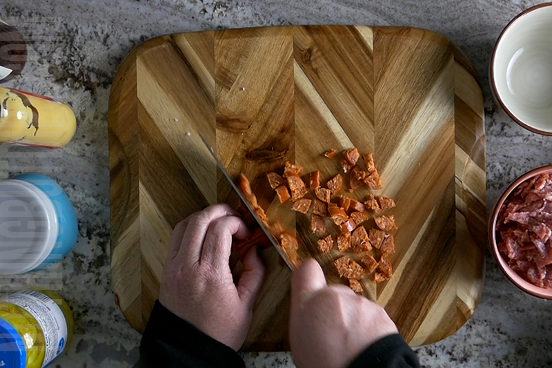 chopping the pepperoni for italian sub dip