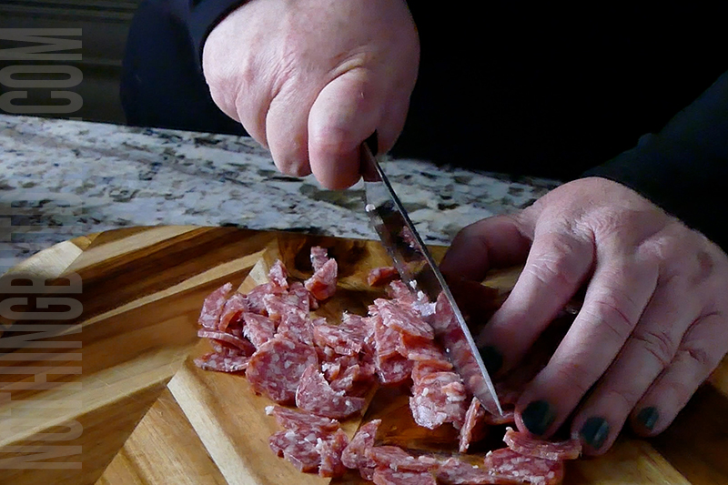 chopping the salami for italian sub dip