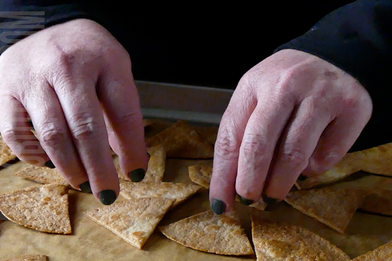 flip the baked tortilla chips on the baking sheet and coat with cooking spray